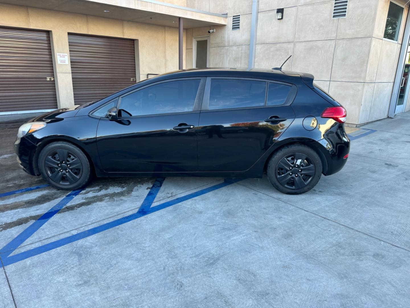 2016 Black /Black Kia Forte 5-Door Cloth (KNAFK5A87G5) with an 4 CYLINDER engine, Automatic transmission, located at 30 S. Berkeley Avenue, Pasadena, CA, 91107, (626) 248-7567, 34.145447, -118.109398 - Embark on a Journey of Style and Efficiency with the 2016 Kia Forte Hatch - Now Available at Our Premier Pasadena, CA Dealership Welcome to our BHPH dealership in Pasadena, CA, where we proudly present the 2016 Kia Forte Hatch, a vehicle that seamlessly blends stylish design, modern technology, a - Photo#1